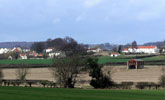 Langton Village with buildings of local stone with pan tile roofs. farms of the Raby Estate are painted white.
